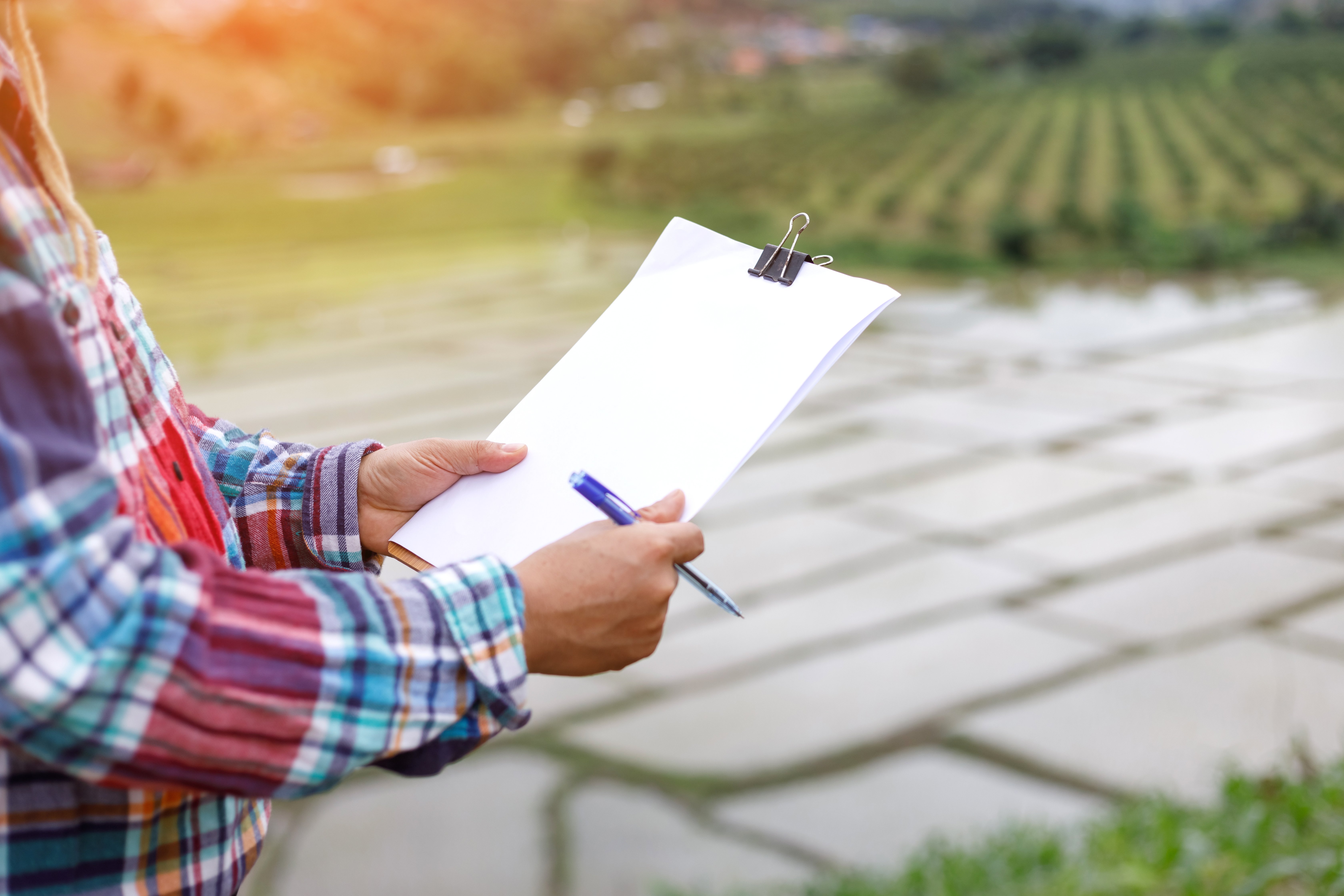 Farmer Holding Resource Paperwork