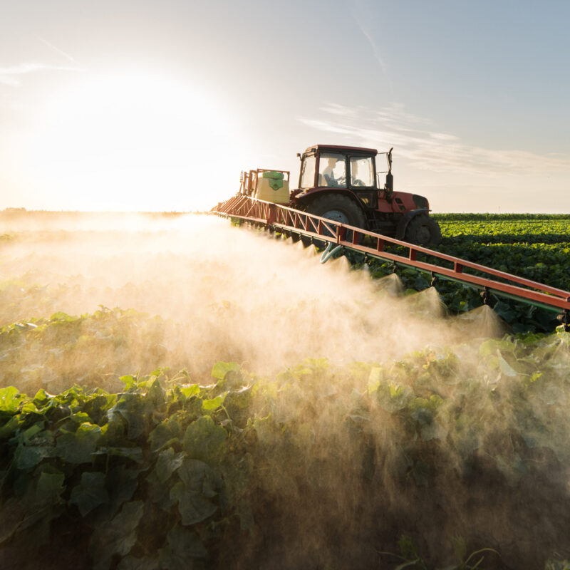 commercial farmer spraying agricultural chemicals on crops